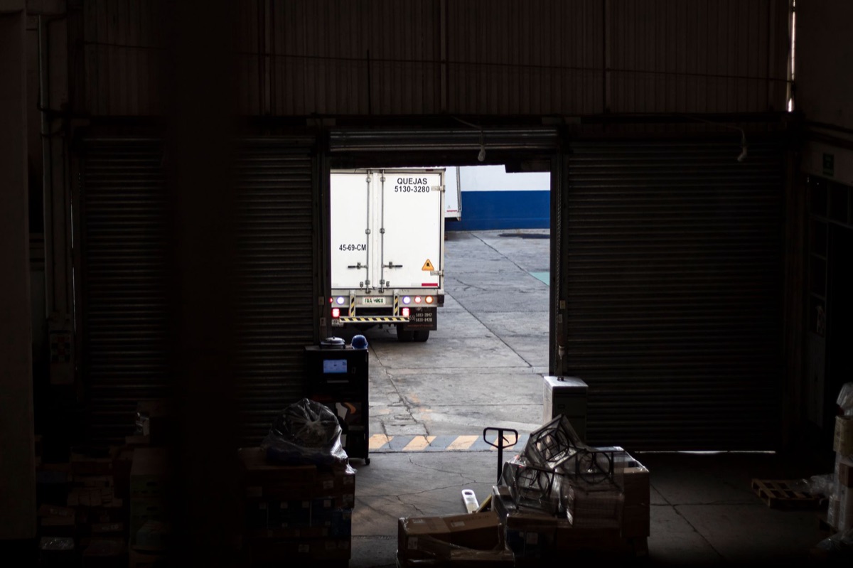 Truck loaded with agricultural products exits Amazon, heading to distant markets.