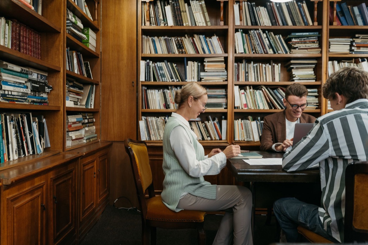Library study room, researcher with newspaper