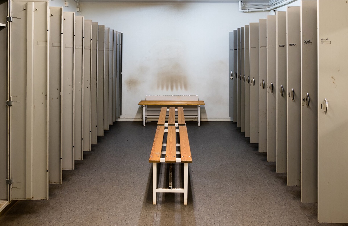 Players in a locker room discussing strategy.